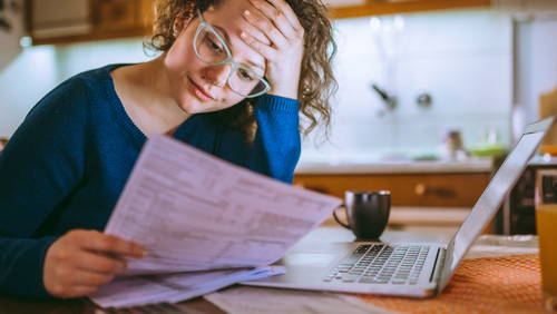 stressed woman with bills